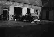 1930's car in the
                stableyard at Chiswick House, being washed